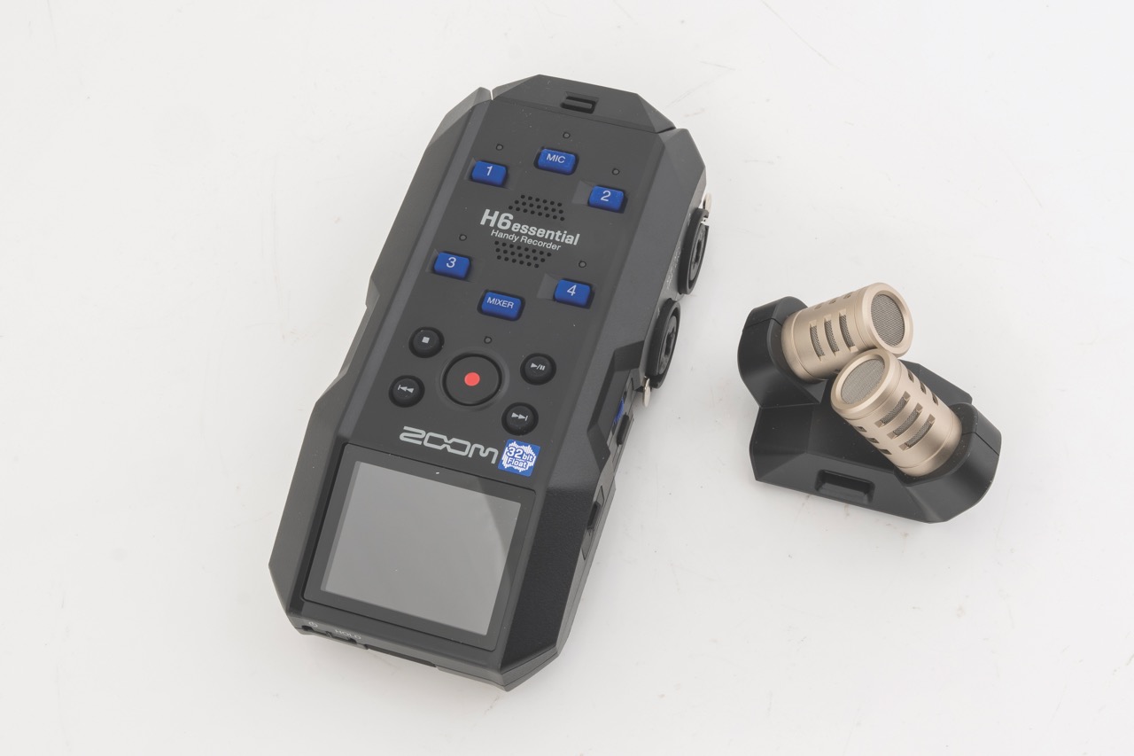 A black audio recording device with detachable microphones