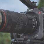 A Canon camera with a long lens placed outside