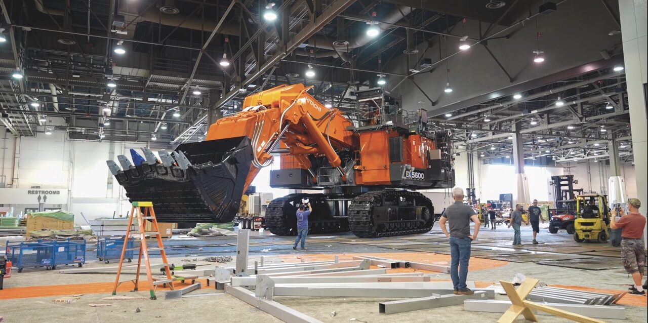 A large orange digger in an industrial warehouse