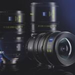 Three camera lenses standing next to each other. Two are horizontal while one is laying on its side