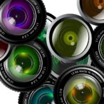 A collection of camera lenses of varying colours