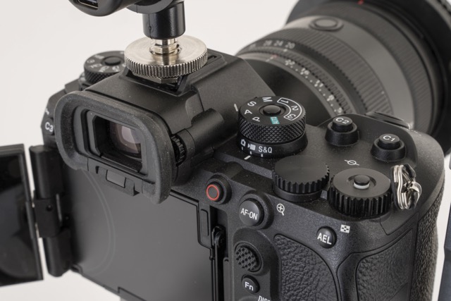 The back of a black camera showing the open screen and the viewfinder