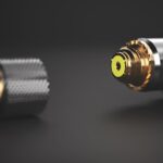 An electrical plug seperator from the connector. The wires are against a black background