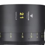 A large black and silver camera lens with yellow numbers on