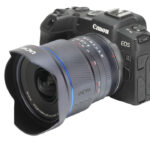 A small rectangular camera with a boxy lens attached, against a white background