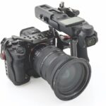 A camera with a large lens facing the diagonal with a rigging device attached