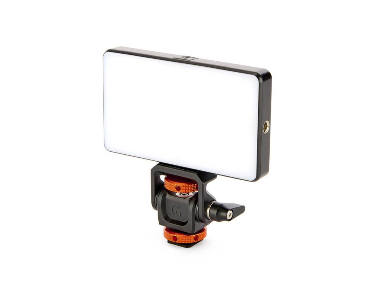 An orange and black tripod device with a rectangle white light attached to the top
