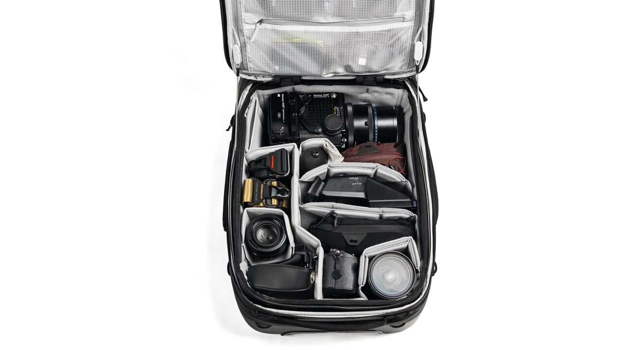 An open suitcase with a lid. Items are arranged neatly within the bag