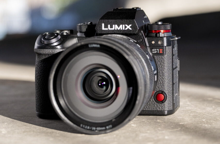 A black Lumix camera with a lens attached sitting in sunlight
