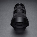 A black lens on a grey surface in low lighting