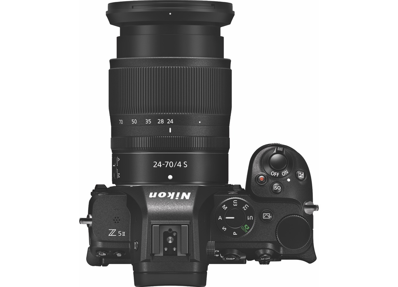 Top view of a black camera by Nikon with a large lens attached