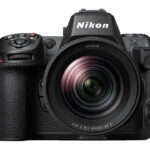 A black Nikon camera with a textured front