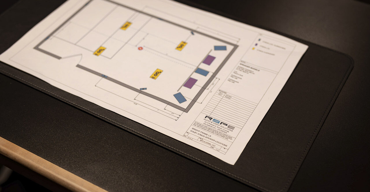 A floor plan on a table showing the layout of a recording studio