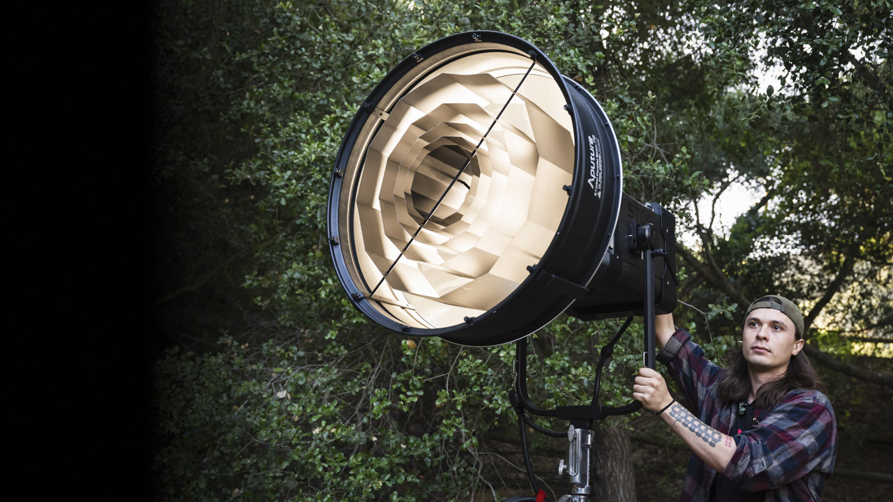 A large light from Aputure set up outside next to a man