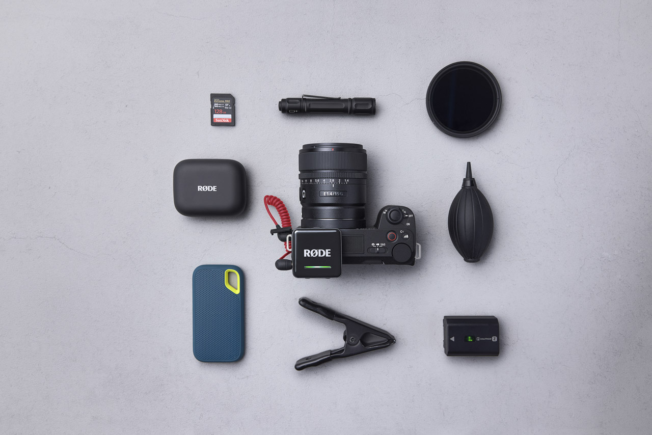 A top-view of a collection of camera accessories with a camera in the middle