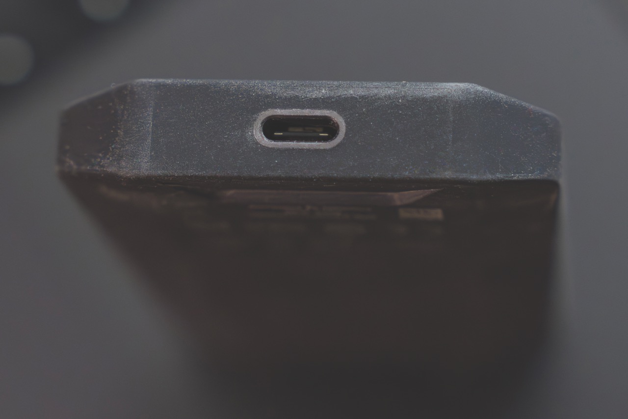 The port of a SanDisk storage device as it stands vertically