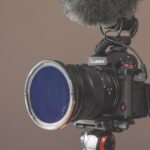 A professional camera from Panasonic with a fluffy microphone above, against a brown background