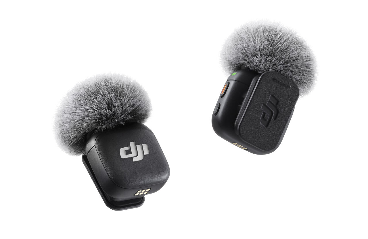 Two small microphones from DJI with fluffy grey heads, against a white background