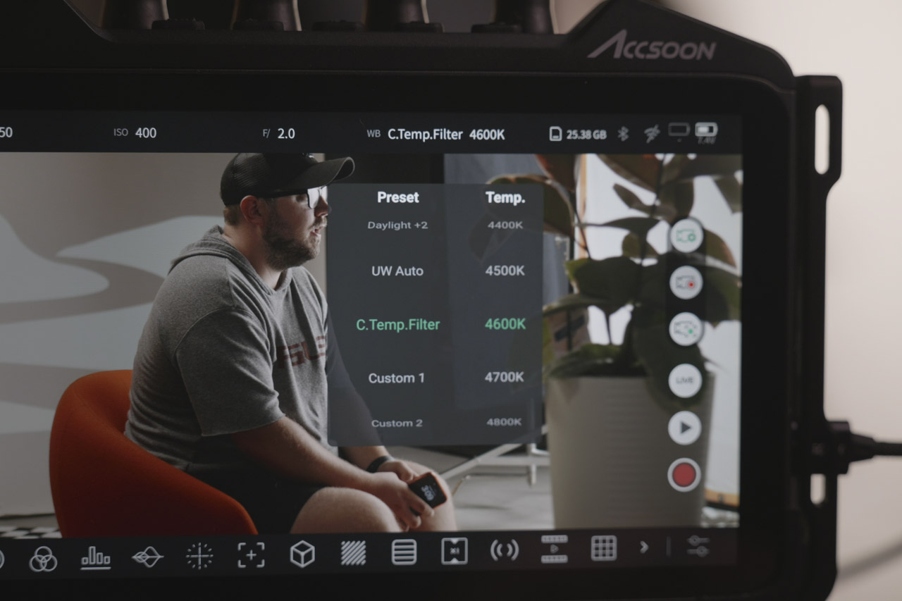 The edge of a touchscreen showing a menu and a man sitting on a seat