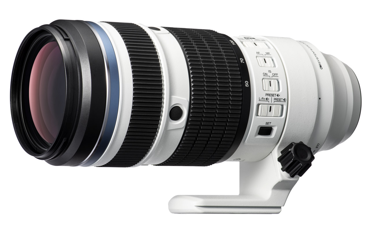 A white and black telephoto lens from OM System, against a white background