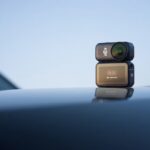 A small portable camera affixed to a smooth, shiny surface