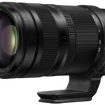 A zoom lens from Panasonic with a stand, against a white background