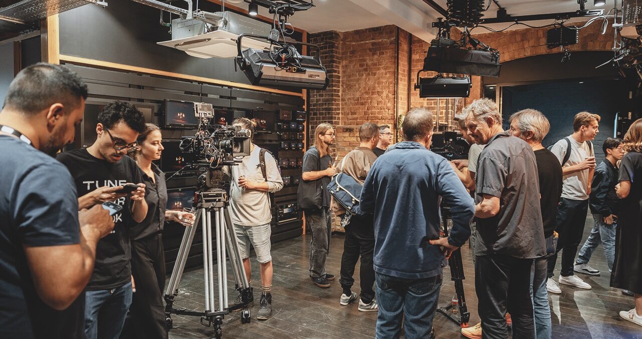 A busy shop floor at CVP with people discussing camera equipment