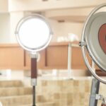 A woman sits at a table vlogging her makeup, surrounded by Harlowe lighting