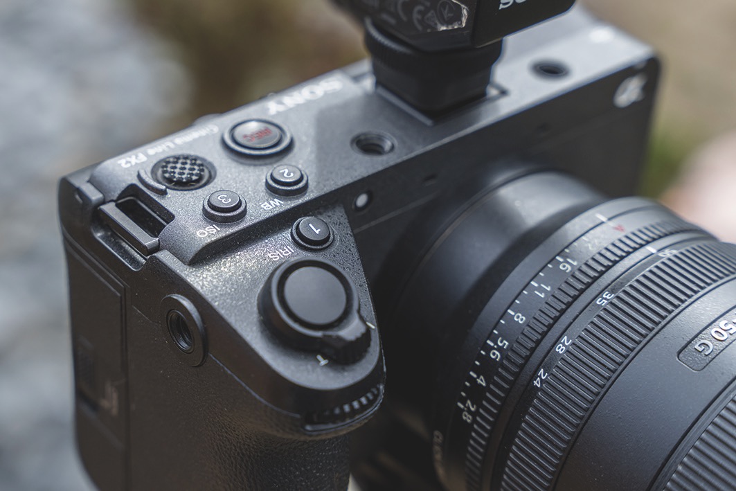 Close up of the dials and buttons on the top of a Sony FX2 camera, positioned outside