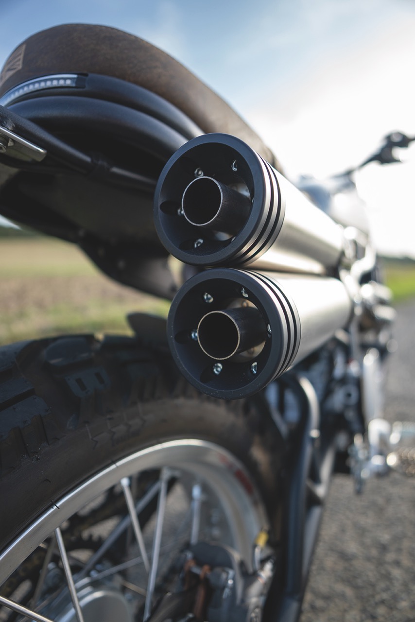 Close up of the exhaust pipes on a motorcycle, stationary outside