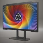 A monitor on a stand from Atomos showing the logo against a grey background