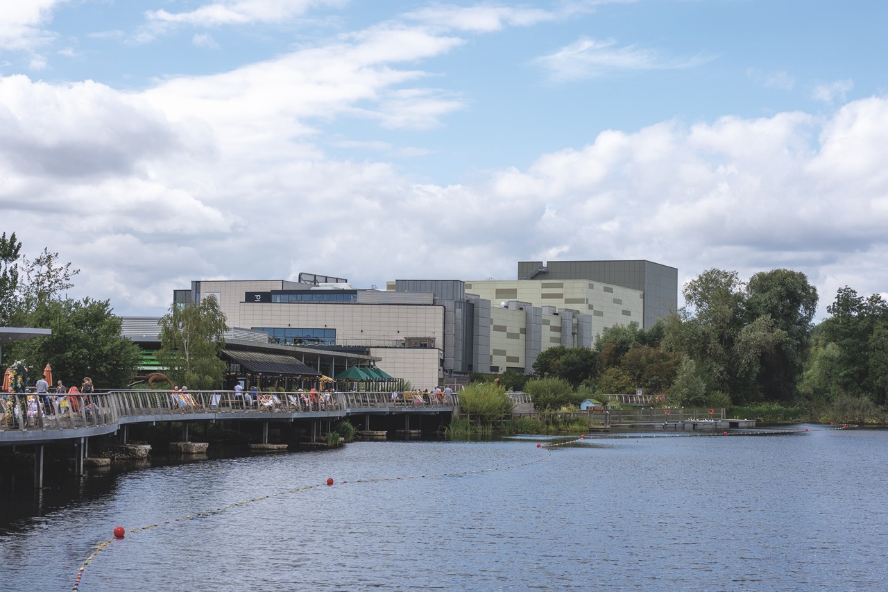A river cityscape with a large building in the background