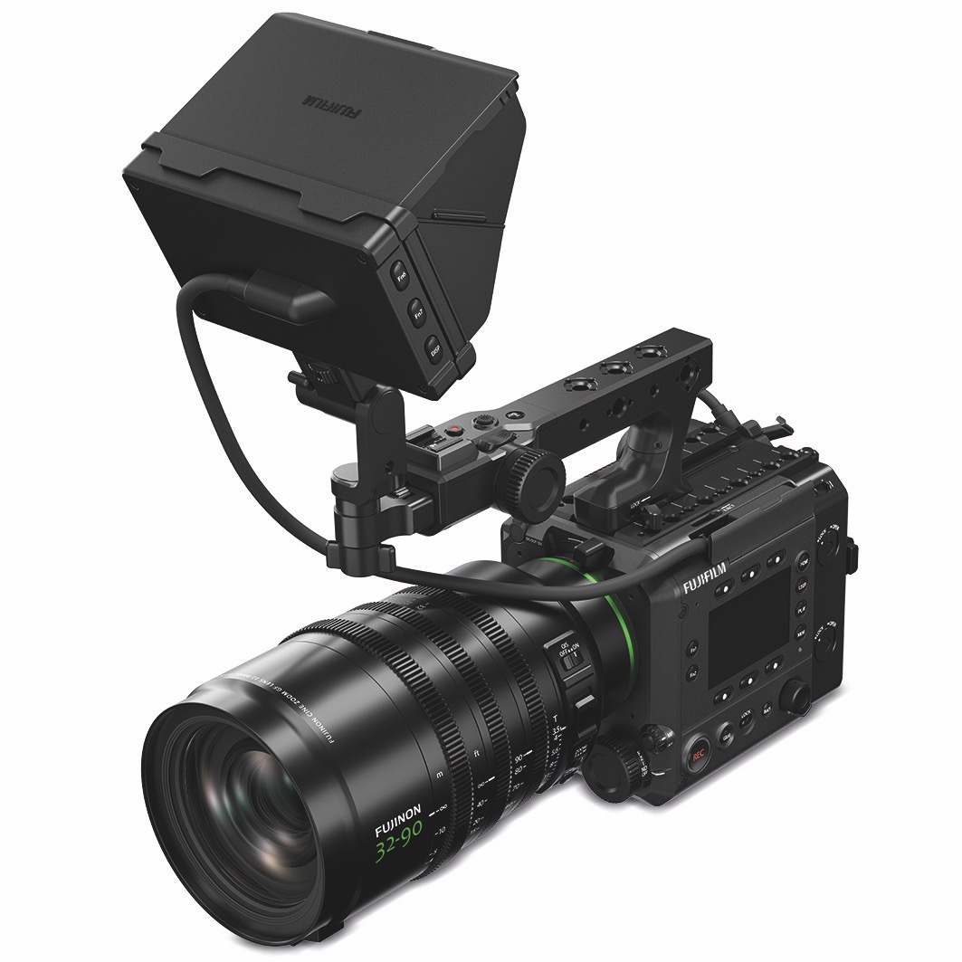 A professional black camera from Fujifilm with a long lens and a monitor attached to the top, against a white background