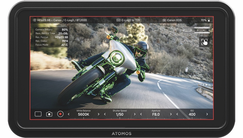 A monitor from Atomos showing a person going around a corner on a green and black motorbike