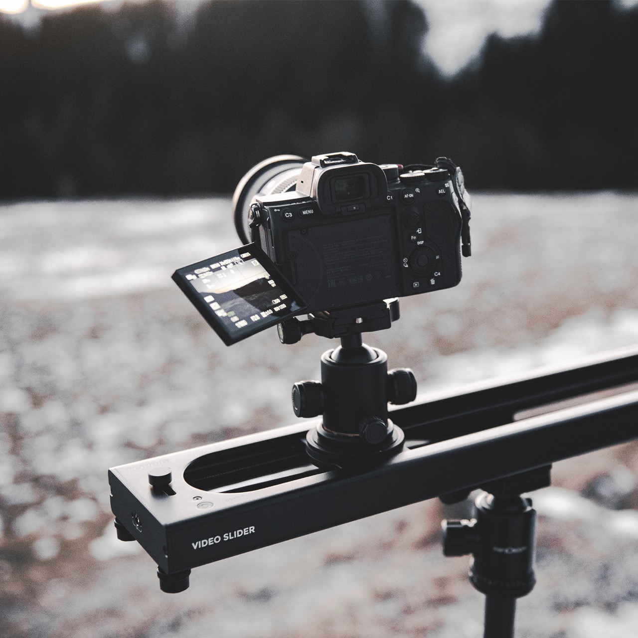 A camera on an Accsoon slider, filming a space-like background