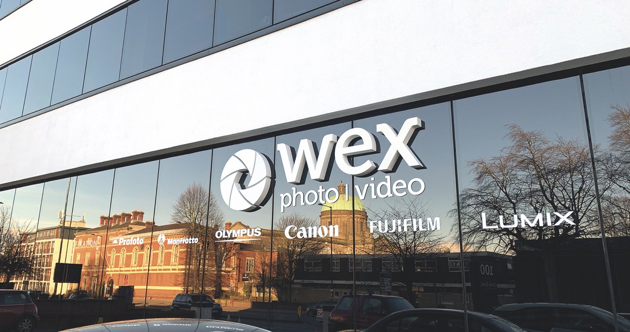 The front of a Wex store front with long glass windows