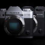 A diagonal line of different coloured Fujifilm X-T30 III cameras, against a black background