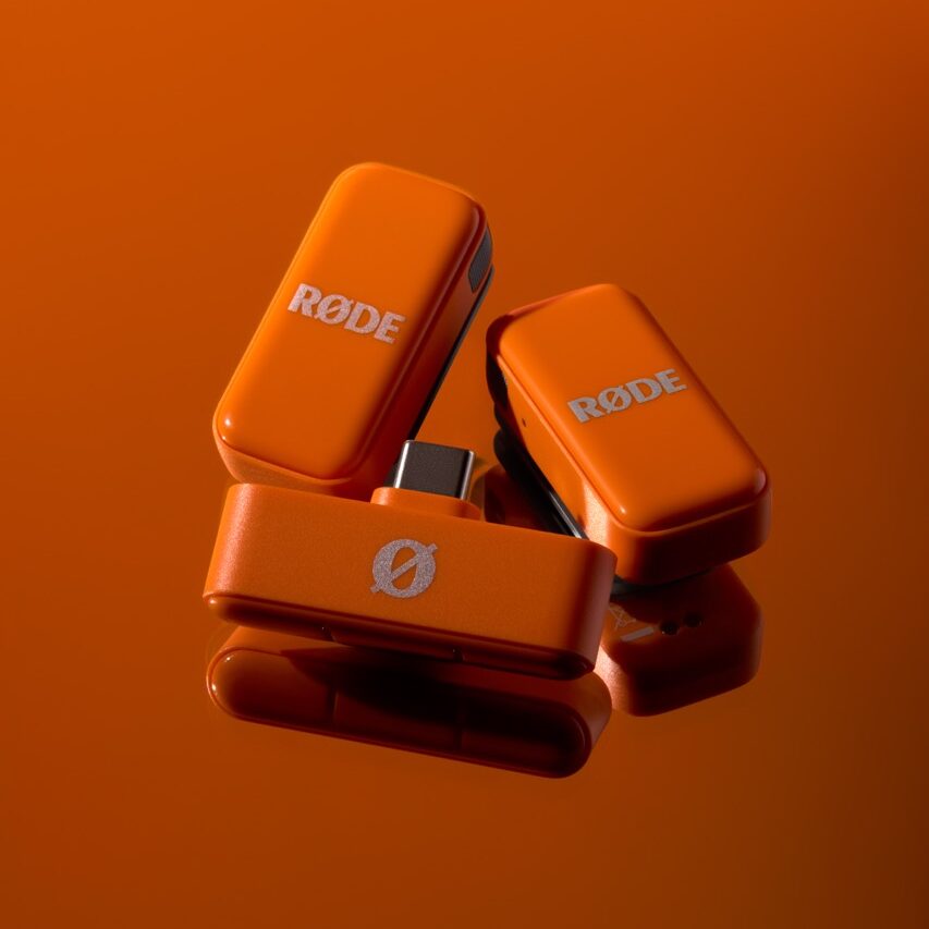 A collection of orange microphones from Rode, against an orange background