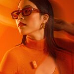 A woman dressed in orange with blurred movement lines extending from her
