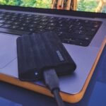 A Samsung drive placed on a laptop, outside on a car