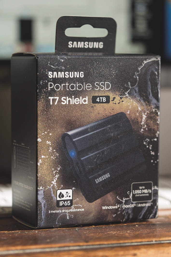 A box from Samsung containing a portable SSD drive, placed on a table
