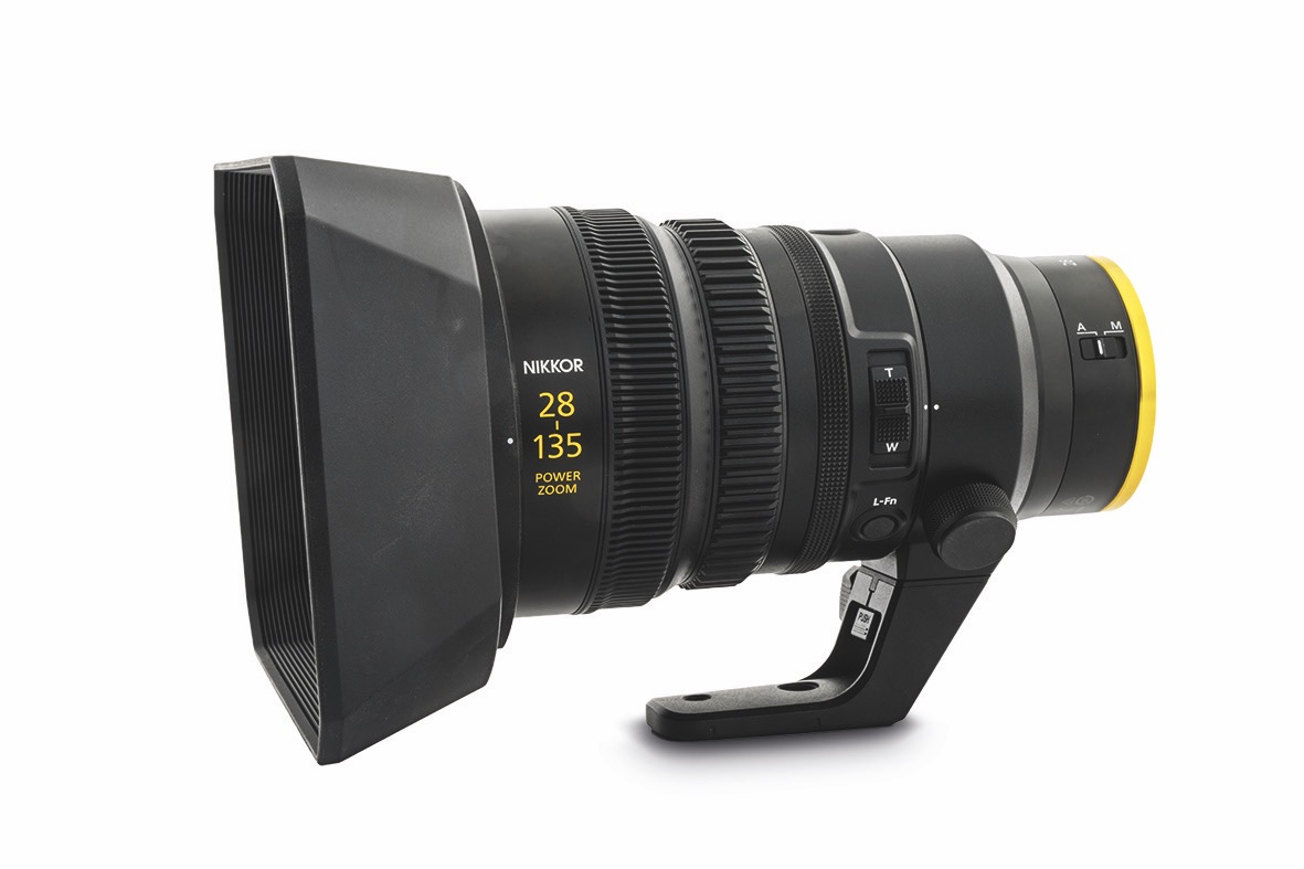 The 28-135mm is ideal for Nikon Z or Red cameras and handles flare decently when provoked A professional lens with a yellow rim and a stand, against a white background