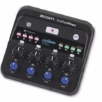 A recording console from Zoom with rows of dials and buttons, against a white background