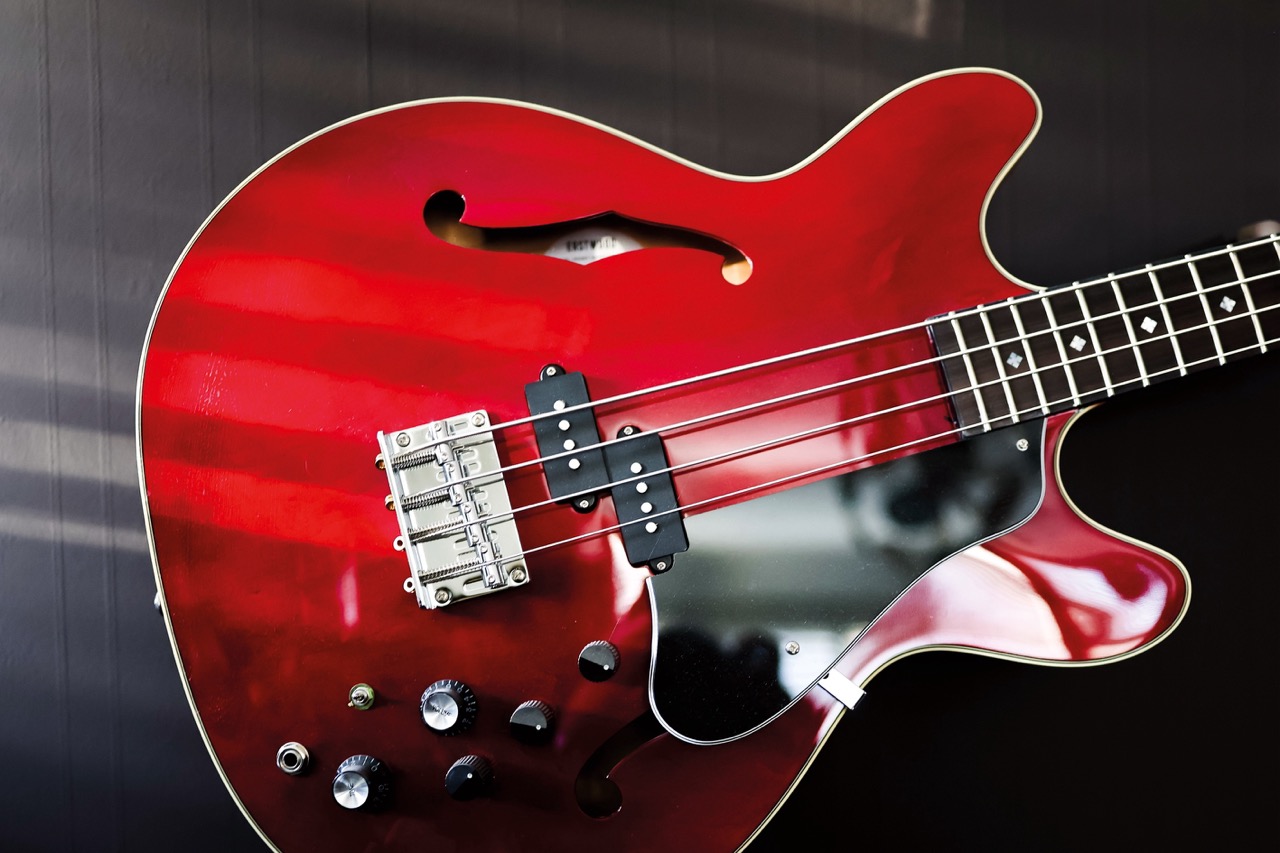 Close-up of the end of a red electric guitar