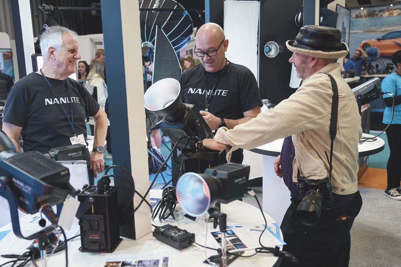 A group of people discussing lights on a table