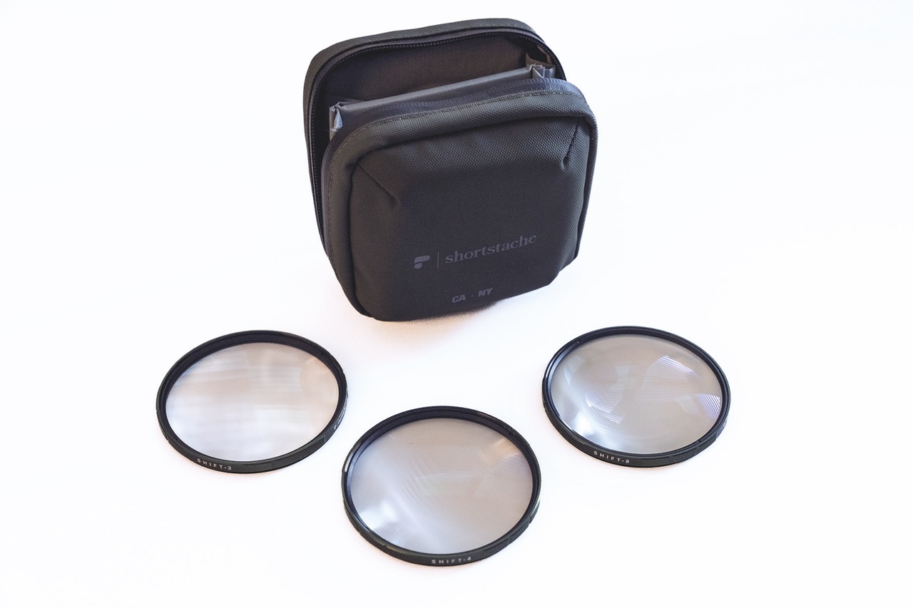 A black case with three filters from Polarpro spread out in front of the bag