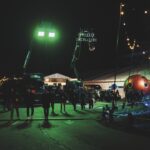 A film set at night, illuminated by a large green light