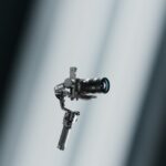 A camera in a DJI gimbal, floating in rays of white light