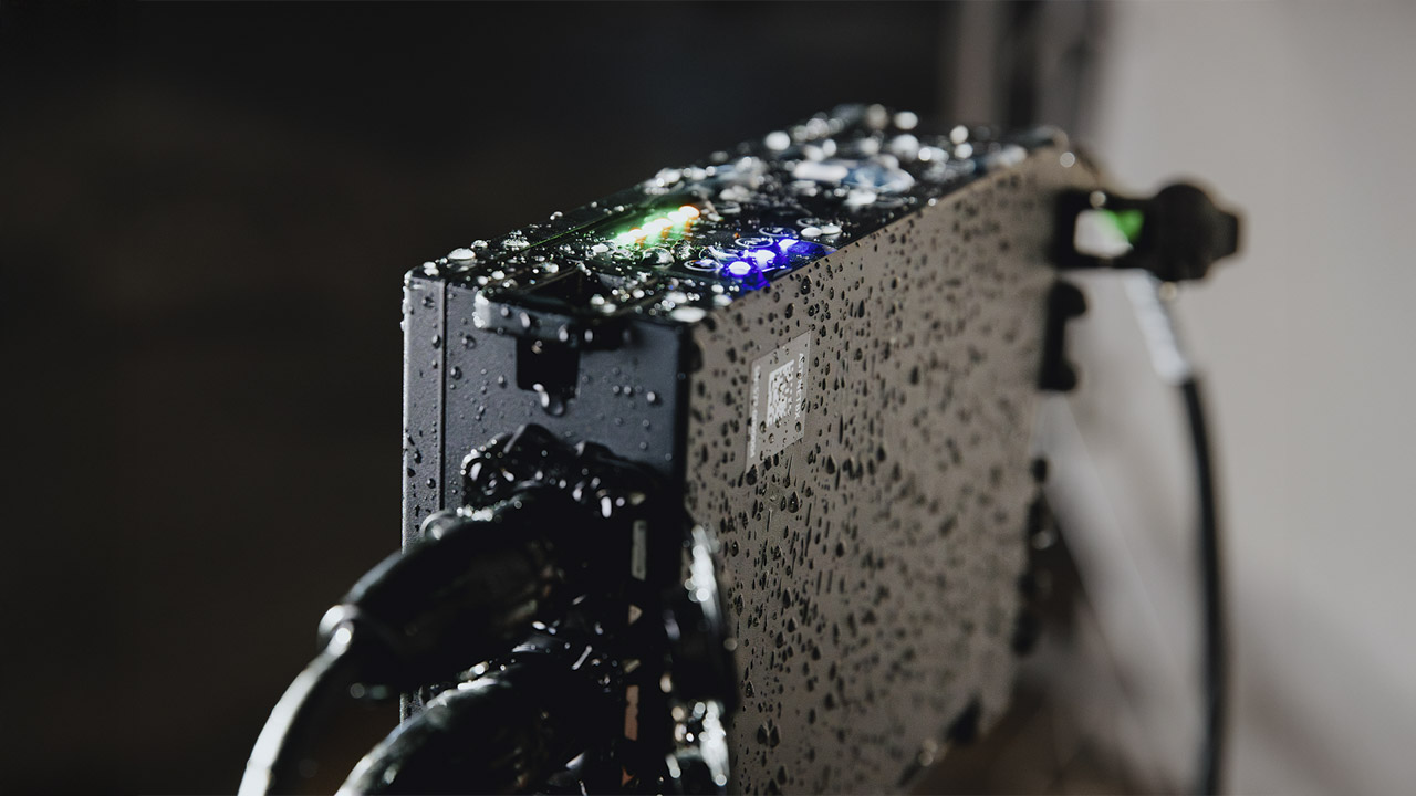 A device from Astera with cables attached to the side and flashing lights on top