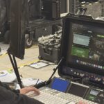 A person working on a high-tech monitor in a film studio